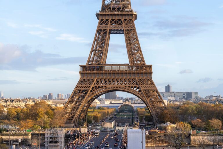 Capture of the iconic Eiffel Tower surrounded by autumn foliage in Paris, France.